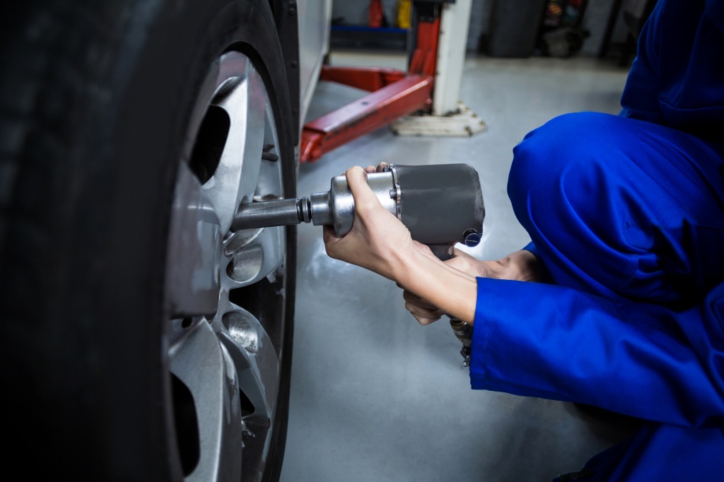 hands-of-female-mechanic-fixing-a-car-wheel-with-pneumatic-wrench.jpg